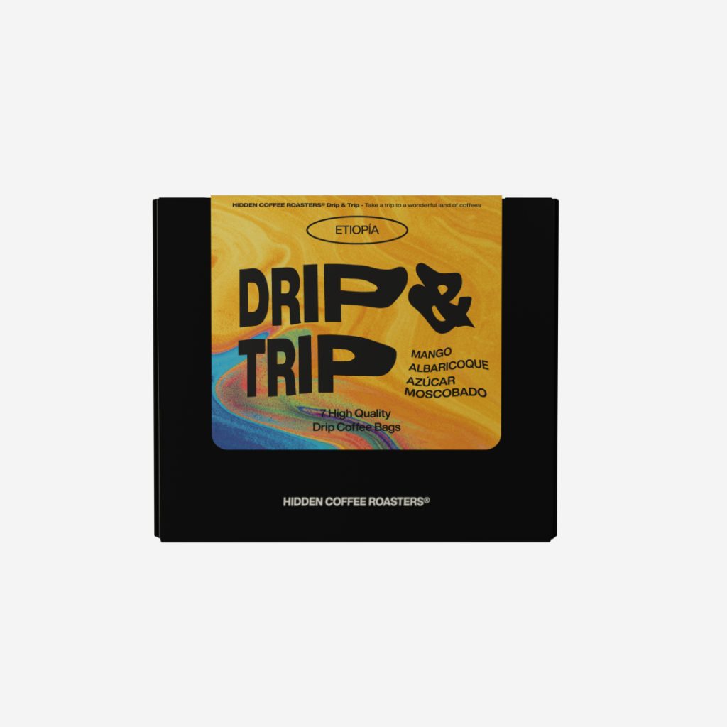 Caja negra de Hidden Coffee Roasters con etiqueta marmoleada amarilla y tipografía bold negra con el texto Drip & Trip Etiopía